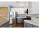 Bright kitchen with white and gray cabinets, stainless steel refrigerator, and modern appliances at 224 Devotion Ct, Henderson, NV 89052