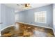 Bright living room with large windows, tiled floors, and modern ceiling fan at 224 Devotion Ct, Henderson, NV 89052