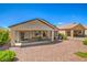 Beautiful backyard featuring a covered patio, desert landscaping, and outdoor seating area at 2539 Stardust Valley Dr, Henderson, NV 89044