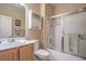 Bathroom featuring a vanity with a mirror, toilet, and a shower-tub combination with sliding glass doors at 2539 Stardust Valley Dr, Henderson, NV 89044