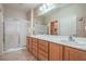 A spacious bathroom with double sinks, vanity, and a glass-enclosed shower for a spa-like experience at 2539 Stardust Valley Dr, Henderson, NV 89044