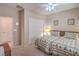 Bright bedroom with two twin beds, closet, carpeted floor, and a ceiling fan for air circulation at 2539 Stardust Valley Dr, Henderson, NV 89044