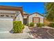 Inviting home exterior with a landscaped front yard, walkway, and attached two-car garage at 2539 Stardust Valley Dr, Henderson, NV 89044