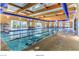 Well-lit indoor pool with multiple lanes, ample seating, and a comfortable environment for swimming at 2539 Stardust Valley Dr, Henderson, NV 89044