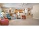 Spacious living room with neutral tones, carpet, ceiling fans, and adjacent dining and kitchen areas at 2539 Stardust Valley Dr, Henderson, NV 89044
