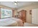 A sunlit bedroom featuring an ornate wardrobe and large window, perfect for a restful night's sleep at 2539 Stardust Valley Dr, Henderson, NV 89044
