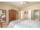 This bedroom is accented with a large wardrobe and provides access to the ensuite bathroom for added privacy at 2539 Stardust Valley Dr, Henderson, NV 89044