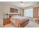 Comfortable bedroom features a large window, ceiling fan, and decorative artwork for a relaxing retreat at 2539 Stardust Valley Dr, Henderson, NV 89044