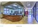 Welcoming reception desk area featuring stylish wood finishes and tile flooring, creating an inviting atmosphere at 2539 Stardust Valley Dr, Henderson, NV 89044
