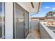A balcony featuring a sliding glass door overlooking the complex and nearby parking at 2838 Geary Pl # 4002, Las Vegas, NV 89109