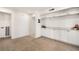 Finished basement space with built-in white cabinets, neutral carpeting, and ample storage at 2838 Geary Pl # 4002, Las Vegas, NV 89109