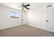 A bright bedroom with carpet, ceiling fan, and a sunlit window showcasing city views at 2838 Geary Pl # 4002, Las Vegas, NV 89109