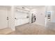 Welcoming entryway featuring white cabinets, neutral flooring, and a view of the modern kitchen at 2838 Geary Pl # 4002, Las Vegas, NV 89109