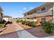 Exterior view of townhomes featuring brick, siding, lush landscaping, and walkways at 2838 Geary Pl # 4002, Las Vegas, NV 89109