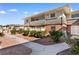 A townhouse exterior with landscaped pathway, partial brick facade, and covered balcony at 2838 Geary Pl # 4002, Las Vegas, NV 89109