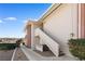 Exterior view of a multi-story apartment building featuring stucco walls and a stairway at 2838 Geary Pl # 4002, Las Vegas, NV 89109