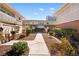 Exterior view of multi-Gathering residence with a manicured courtyard and walking path at 2838 Geary Pl # 4002, Las Vegas, NV 89109