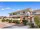 Exterior of a multi-Gathering townhouse complex, showing the walkway, landscaping, and building at 2838 Geary Pl # 4002, Las Vegas, NV 89109