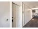 Hallway view to unit door featuring neutral carpet and uniform fixtures at 2838 Geary Pl # 4002, Las Vegas, NV 89109