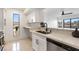 Bright kitchen featuring stone countertops, stainless steel sink and fixtures, and white cabinetry at 2838 Geary Pl # 4002, Las Vegas, NV 89109