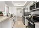 Modern kitchen features stainless steel appliances, white cabinets, and light stone countertops at 2838 Geary Pl # 4002, Las Vegas, NV 89109