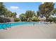 Inviting pool with a clear blue water surrounded by trees at 2838 Geary Pl # 4002, Las Vegas, NV 89109