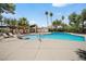 Inviting pool with a clear blue water surrounded by mature trees and lounge chairs at 2838 Geary Pl # 4002, Las Vegas, NV 89109