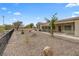 Large, private backyard features desert landscaping, a covered patio, and mature trees at 2999 Gettysburg Ave, Henderson, NV 89052