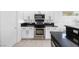 Close up of a modern kitchen with stainless steel appliances, dark countertops and white cabinets at 2999 Gettysburg Ave, Henderson, NV 89052
