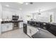 Modern kitchen with stainless steel appliances, dark countertops, white cabinets, and tiled floors at 2999 Gettysburg Ave, Henderson, NV 89052