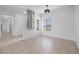 Bright living room featuring tiled flooring, decorative lighting, and large windows allowing ample natural light at 2999 Gettysburg Ave, Henderson, NV 89052