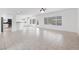 Expansive living space with tile floors, white walls, and abundant natural light flowing into the kitchen area at 2999 Gettysburg Ave, Henderson, NV 89052