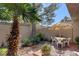 Private backyard features tile patio, shade umbrella, palm tree, and tranquil landscaping at 3380 Pavlo St, Las Vegas, NV 89121