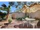 Private backyard with tile patio, lush plants, and outdoor seating provides a relaxing retreat at 3380 Pavlo St, Las Vegas, NV 89121