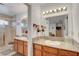 Well-lit bathroom featuring double sinks with granite countertops and a shower with glass doors at 3380 Pavlo St, Las Vegas, NV 89121