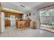 Eat-in kitchen features a breakfast bar, white appliances and tile flooring at 3380 Pavlo St, Las Vegas, NV 89121
