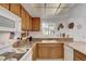 Traditional-style kitchen features wood cabinets, granite countertops, and white appliances at 3380 Pavlo St, Las Vegas, NV 89121