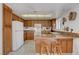 The kitchen features granite countertops, bar seating, and bright lighting at 3380 Pavlo St, Las Vegas, NV 89121