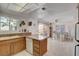 Bright eat-in kitchen with tiled floors, wood cabinets, granite countertops, and adjacent dining area at 3380 Pavlo St, Las Vegas, NV 89121