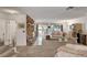 Comfortable living area with a stone fireplace, sliding glass doors, and lots of natural light at 3380 Pavlo St, Las Vegas, NV 89121