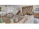 Spacious living room with a stone fireplace, plush sofa, and a glass-top coffee table at 3380 Pavlo St, Las Vegas, NV 89121