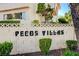 Pecos Villas community sign surrounded by lush, mature landscaping provides an inviting entrance at 3380 Pavlo St, Las Vegas, NV 89121