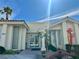 Exterior view of the community clubhouse featuring white stucco and desert landscaping in a sunny setting at 3550 Bay Sands Dr # 1005, Laughlin, NV 89029