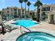 Community pool and hot tub surrounded by lounge chairs and palm trees with condo buildings in the background at 3550 Bay Sands Dr # 1005, Laughlin, NV 89029
