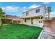 Expansive backyard featuring lush green grass and a covered patio area for outdoor enjoyment at 3644 Shanagolden St, Las Vegas, NV 89129