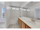 Bright bathroom featuring a tub, shower, large mirror, and a vanity, with light gray flooring at 3644 Shanagolden St, Las Vegas, NV 89129