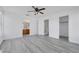 This bedroom has a ceiling fan, and light gray wood flooring, and it's conveniently located close to the bathroom and stairs at 3644 Shanagolden St, Las Vegas, NV 89129