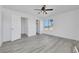 This bedroom features a modern ceiling fan, two closets and light gray wood flooring at 3644 Shanagolden St, Las Vegas, NV 89129