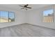 Bedroom showcasing large windows, neutral paint, and gray wood-look floors at 3644 Shanagolden St, Las Vegas, NV 89129
