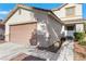 Exterior view of a well-kept home with a two-car garage and a charming front entrance at 3644 Shanagolden St, Las Vegas, NV 89129